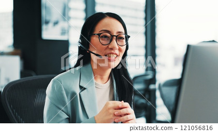 Consultant, telecom or Japanese woman on computer in call center for consulting or loan advice. Explain, virtual assistant or agent talking on pc with service for telemarketing or sales communication 121056816
