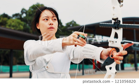 Woman, archer and bow for training, shooting and preparing for competition, equipment and outdoor. Contest, athlete and practice from tournament, skills and challenge for person, game and Japan Woman, archer and bow for training, shooting and preparing for competition, equipment and outdoor. Contest, athlete and practice from tournament, skills and challenge for person, game and Japan 121056820