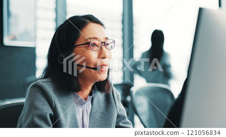 Woman, telemarketing operator and customer support computer in office, talk and advisor to client. Female person, call centre representative and helping consumer with loan in Japan insurance agency 121056834