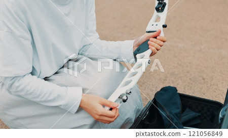 Hands, archer and bow for training, athlete and preparing for competition, equipment and outdoor for game. Contest, sports and practice from tournament, skills and challenge for person in Japan 121056849