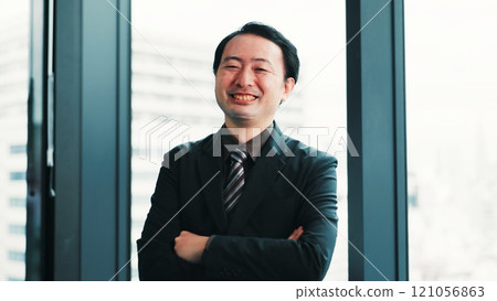 Smile, crossed arms and portrait of businessman in office with confidence for finance career. Happy, pride and Japanese male financial manager with positive attitude for company revenue in workplace. 121056863