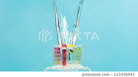 PH acid level test kit on quality water on purple yellow. Water splashing on PH acid level tester kit over blue background 121056942