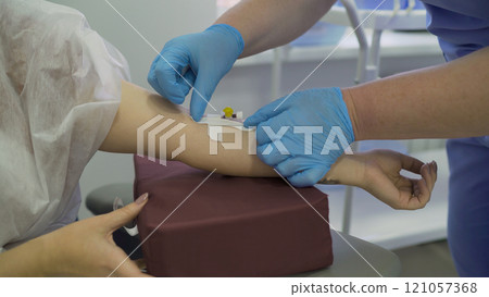 The doctor injects the patient into a vein. Close up - blood test from a vein of the arm. Intravenous anesthesia. 121057368