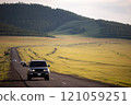Japanese black SUV moving by a road in summer in Mongolia 121059251