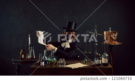 Plague doctor thoughtfully reads recipe, appointment to make ideal medicine for recovery in vintage laboratory against dark mystery background. Plague doctor thoughtfully reads recipe, appointment to make ideal medicine for recovery in vintage laboratory against dark mystery background. 121060710