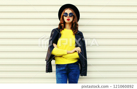 Fashionable stylish young woman posing in black jacket with hat on white background Fashionable stylish young woman posing in black jacket with hat on white background 121060892