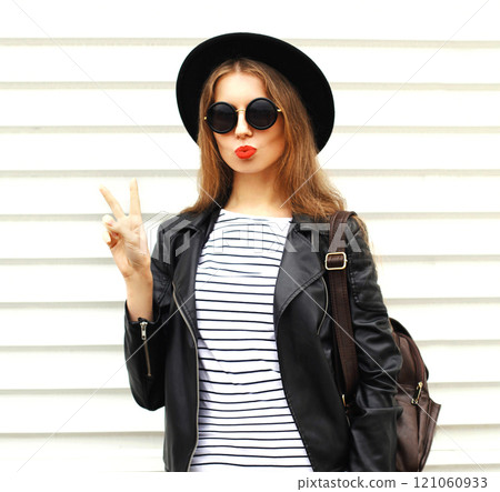 Fashion young woman with backpack bag in black rock style over white background 121060933