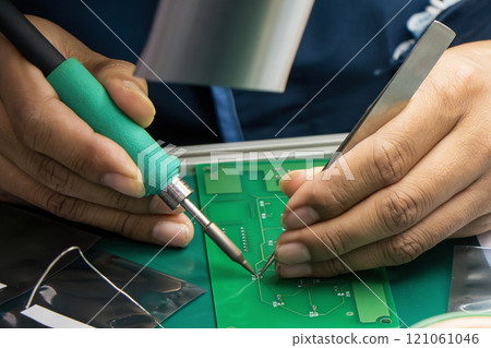 Close up scene the soldering operation by skill operator. 121061046