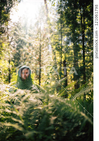 Person Hidden Among Lush Forest Ferns Person Hidden Among Lush Forest Ferns 121061798