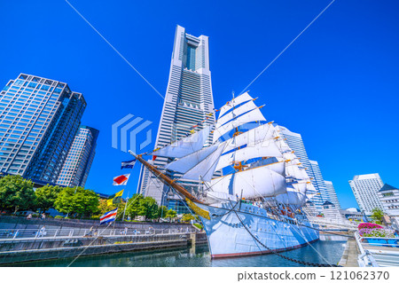 Yokohama cityscape in Japan: Towards a new era...View of the Nippon Maru with full sails and Yokohama Landmark Tower. A ray of hope = 3rd 121062370