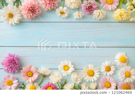 A old wooden plank background with a variety of yellow and white flowers, including daisies on the sides. A old wooden plank background with a variety of yellow and white flowers, including daisies on the sides. 121062469