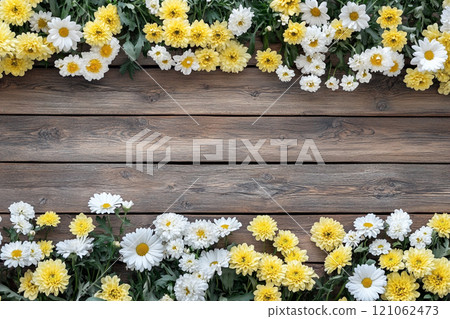 A old wooden plank background with a variety of yellow and white flowers, including daisies on the sides. A old wooden plank background with a variety of yellow and white flowers, including daisies on the sides. 121062473