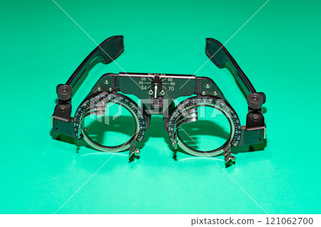 Optometry optics test glasses on a green table. 121062700