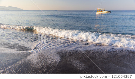 Aegean sea view. Coastal landscape with shore water and wet sand Aegean sea view. Coastal landscape with shore water and wet sand 121064397