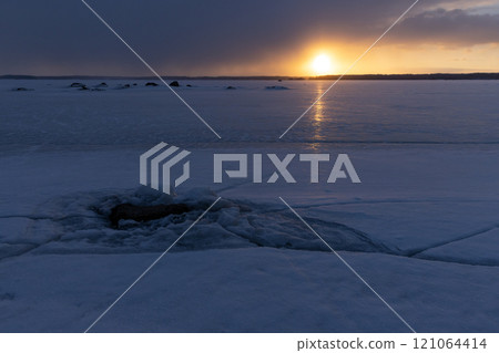 Winter landscape with frozen Baltic sea at sunset Winter landscape with frozen Baltic sea at sunset 121064414