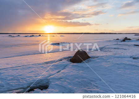 Winter landscape with black rocks and frozen Baltic Sea coast Winter landscape with black rocks and frozen Baltic Sea coast 121064416