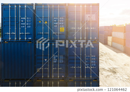 Port storage area with stacked blue cargo containers 121064462
