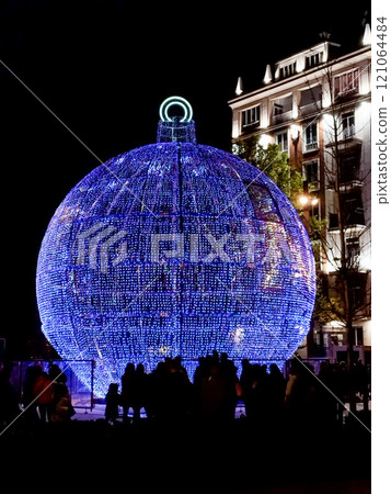 Christmas. Light. Christmas lights through the streets of Madrid. Decorating streets of the city. Fir tree with Christmas lights. Christmas ball. On. MADRID. SPAIN. 11 December 2024. 121064484