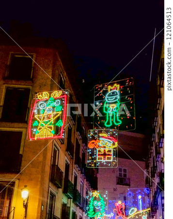 Christmas. Light. Christmas lights through the streets of Madrid. Decorating streets of the city. Fir tree with Christmas lights. Christmas ball. On. MADRID. SPAIN. 11 December 2024. 121064513