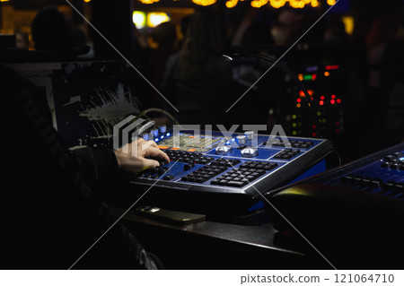 Sound engineer works at a mixing console, close-up 121064710