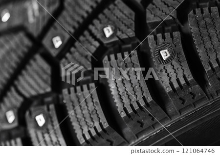 New studded car tire with metal studs embedded within the tread New studded car tire with metal studs embedded within the tread 121064746