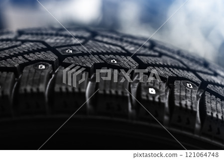 Brand new studded tire with metal studs embedded within the tread Brand new studded tire with metal studs embedded within the tread 121064748