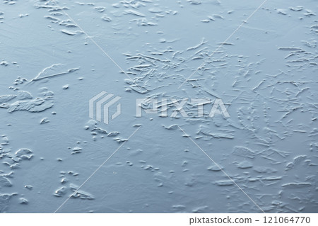 Thin ice layer on a frozen lake, natural winter background photo 121064770
