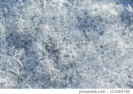 Crystals of ice melting in a sunlight, natural background texture Crystals of ice melting in a sunlight, natural background texture 121064780