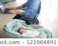 A father who works remotely from home while raising a baby 121064891