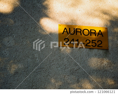 Golden plaque on plastered wall. Inscription Aurora and numbers 241-252. Apartment number in holiday camp. Gold hotel rooms sign. Background for subtitles or intro. Pula, Croatia - December 1, 2024 Golden plaque on plastered wall. Inscription Aurora and numbers 241-252. Apartment number in holiday camp. Gold hotel rooms sign. Background for subtitles or intro. Pula, Croatia - December 1, 2024 121066121