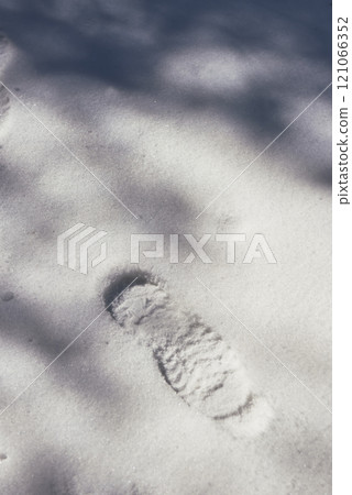 A footprint on virgin snow in sunshine and shadows A footprint on virgin snow in sunshine and shadows 121066352