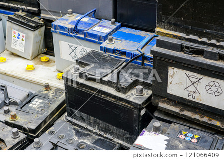 Stack of many used car lead batteries for recycling in a hazardous waste facility 121066409