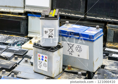 Stack of many used car lead batteries for recycling in a hazardous waste facility 121066410