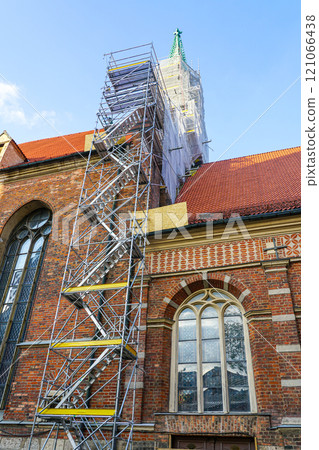 Historic church tower facade restoration using modern very high prefabricated metal tube scaffolding 121066438
