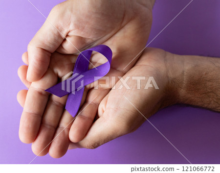 Crossed hands holding purple ribbons,world cancer day concept. Crossed hands holding purple ribbons,world cancer day concept. 121066772