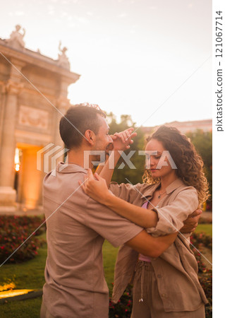 Couple dancing salsa or swing in front of puerta de alcala in madrid at sunset 121067714
