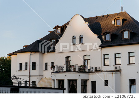 A very large white building prominently displaying the letters eee on it A very large white building prominently displaying the letters eee on it 121067723