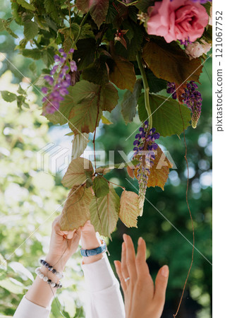 A woman is holding a beautiful bouquet of colorful flowers A woman is holding a beautiful bouquet of colorful flowers 121067752