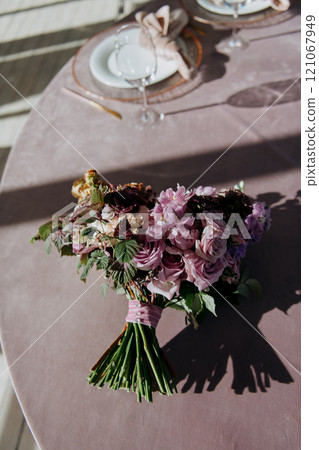 A beautiful bouquet of colorful flowers is sitting on a table A beautiful bouquet of colorful flowers is sitting on a table 121067949