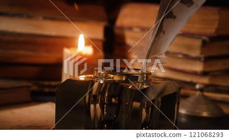Candle Burning On Old Books, Feather Quill Pen In Inkwell Background. Antique Candle Burning On Old Books, Feather Quill Pen In Inkwell Background. Antique 121068293