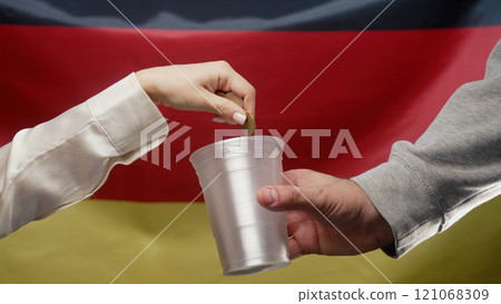 Rich Woman Throws Euro Coin Into Plastic Cup Of Homeless Man Who Is Asking For Rich Woman Throws Euro Coin Into Plastic Cup Of Homeless Man Who Is Asking For 121068309