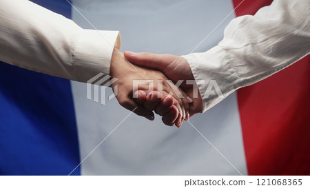 Hands Of Couple Woman And Man Reach Out Each Other On French Flag Background Hands Of Couple Woman And Man Reach Out Each Other On French Flag Background 121068365
