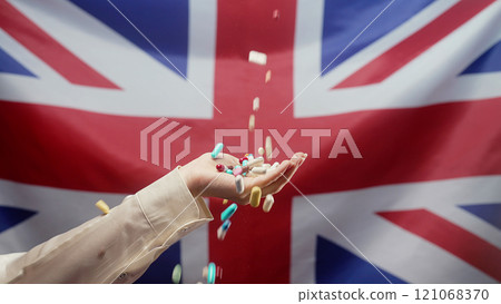 Pills Falling On Female Hand On Great Britain Flag Background. Expensive 121068370