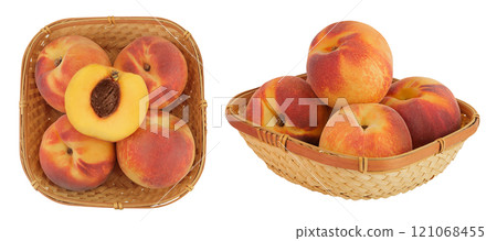 Ripe peach fruit with half in a wicker basket isolated on white background with full depth of field. Top view. Flat lay 121068455