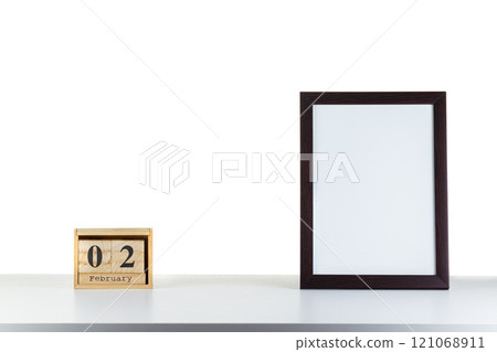 Wooden calendar 02 february with frame for photo on white table and background 121068911
