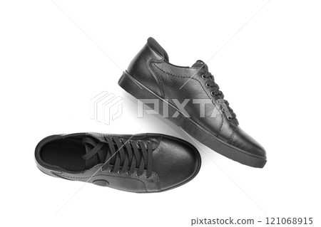 black leather sneakers on a white background 121068915