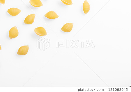 Pasta products in the form of a shell, texture, on a white background Pasta products in the form of a shell, texture, on a white background 121068945