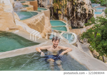 Male tourist at the hot springs of Grutas Tolantongo, Mexico. Adventure, relaxation, and natural wellness concept 121069044