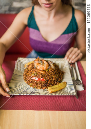 Chaulafan marisco ecuatoriano, Gastronomy. Typical dinner dish close-up. Unrecognizable woman hand 121069318
