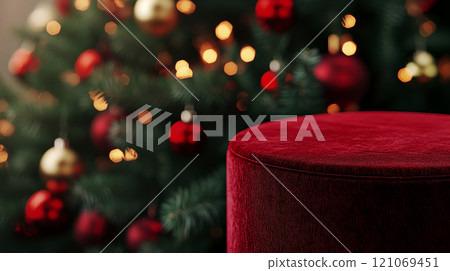 Empty red podium for product photography. Shiny blurred background with bokeh, baubles, decorated Christmas tree and spruce branches. Mockup pedestal on a table. 121069451